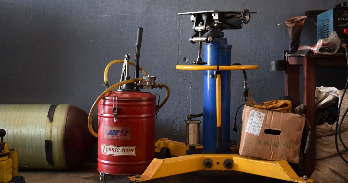 Workshop with a drill press, gas cylinders and tools