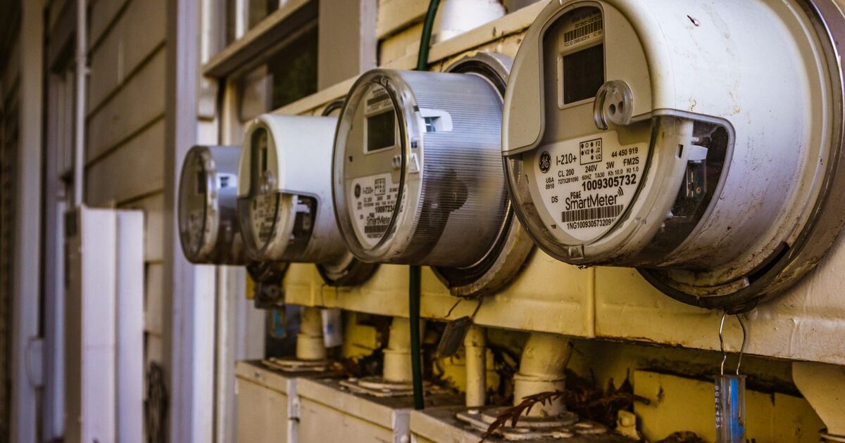 Multiple digital electricity meters mounted on an exterior wall